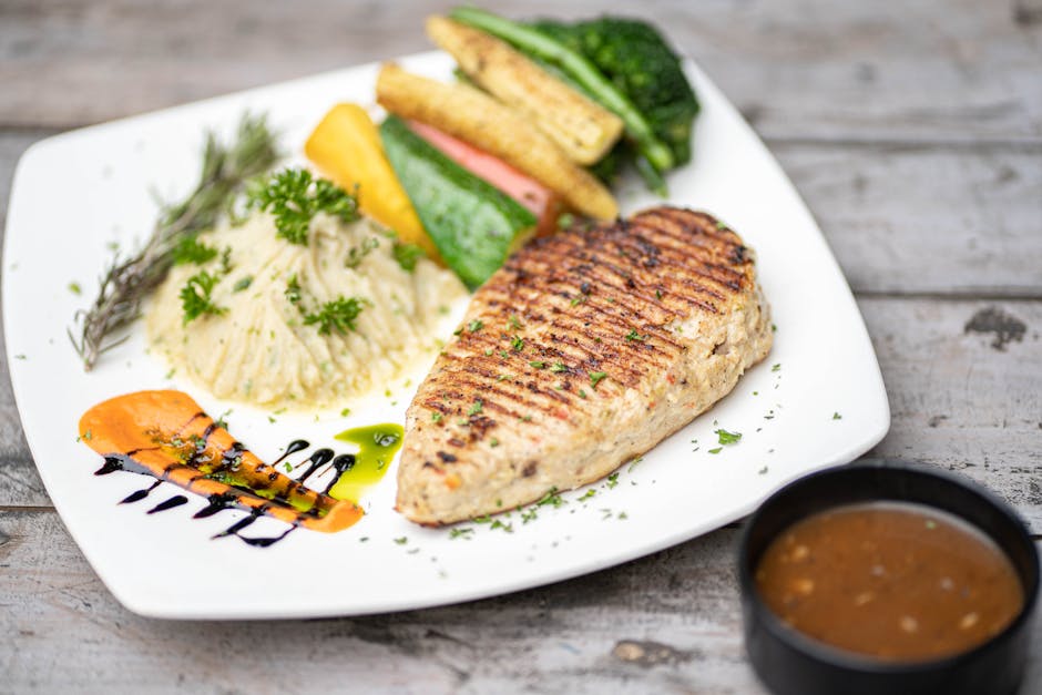 Grilled chicken breast on a plate with vegetables - high protein meal